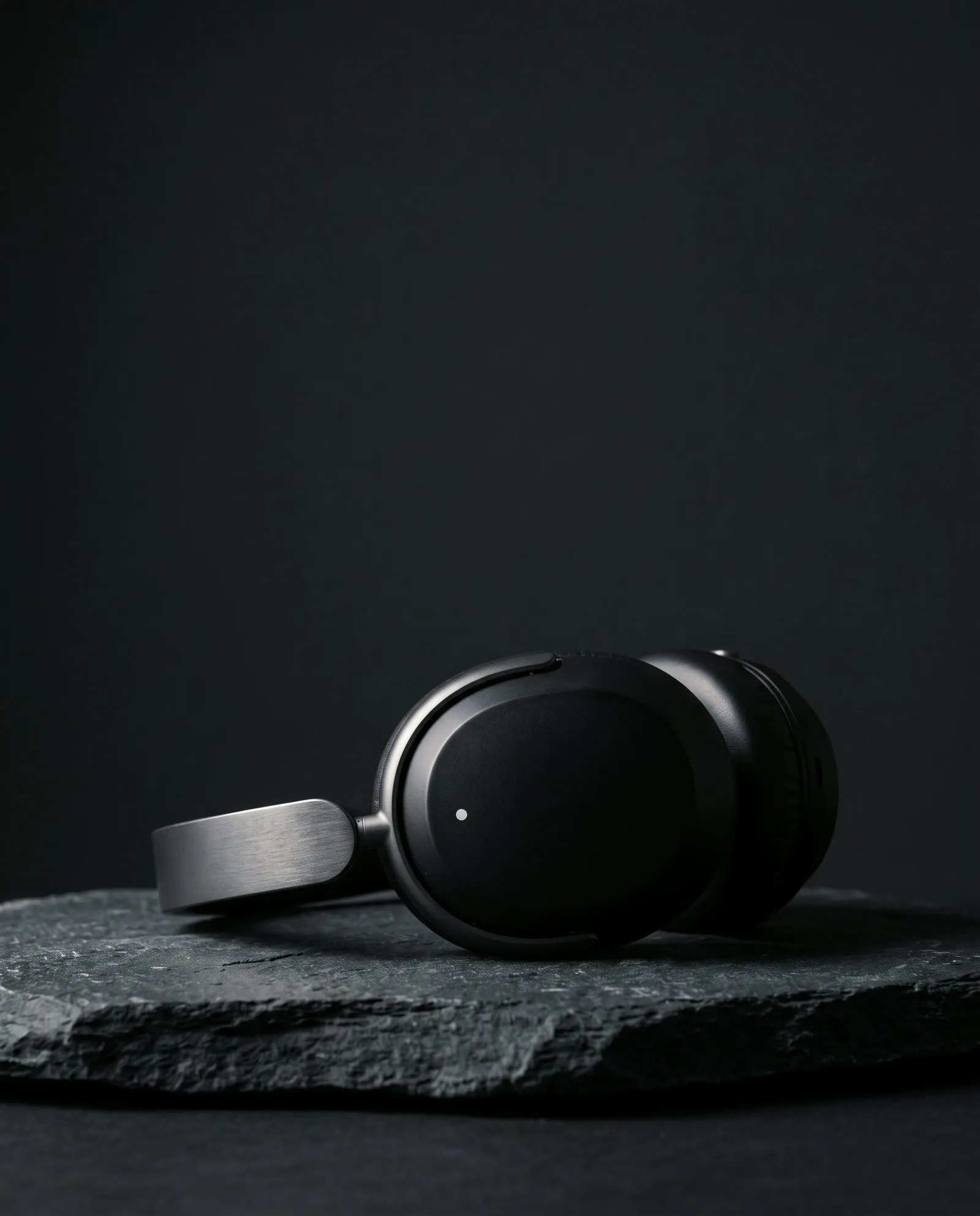 Still headphones resting on dark stone